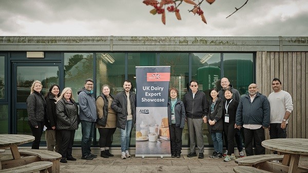 People stood next to UK dairy export showcase sign